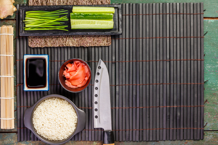 Bamboo mat with sushi-making ingredients and supplies