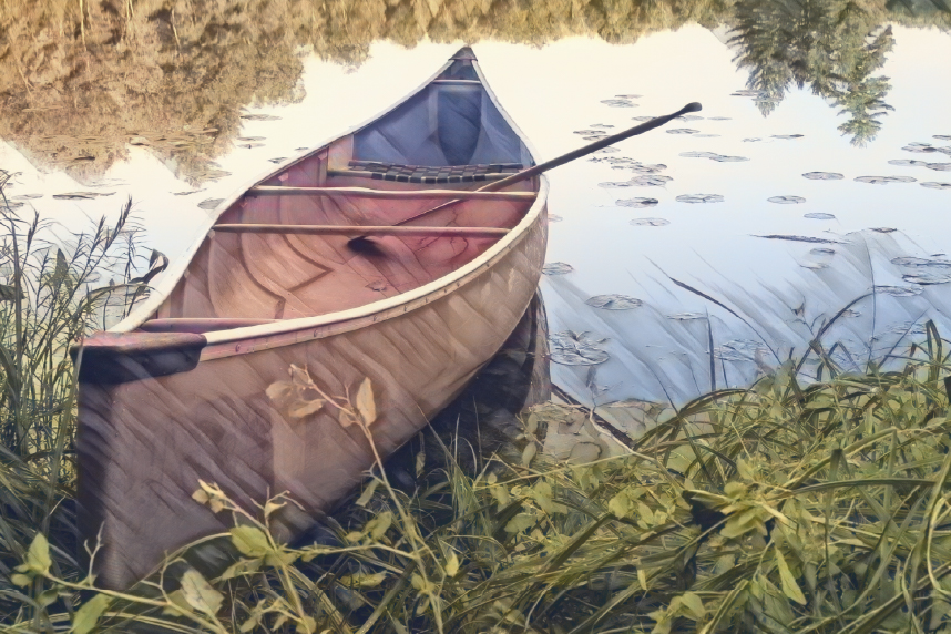 Empty canoe on river bank