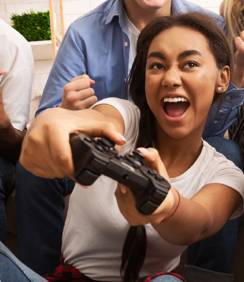 Excited teenager playing a game with video game controller