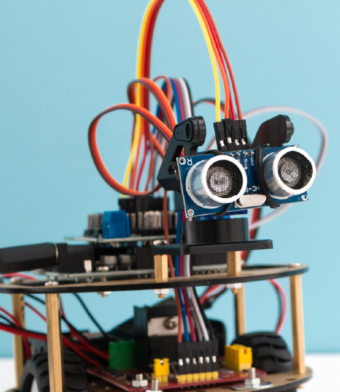 Hand-build mini-robot on light blue background