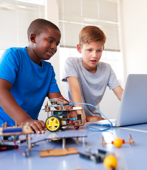 Two boys with handbuilt robot and laptop
