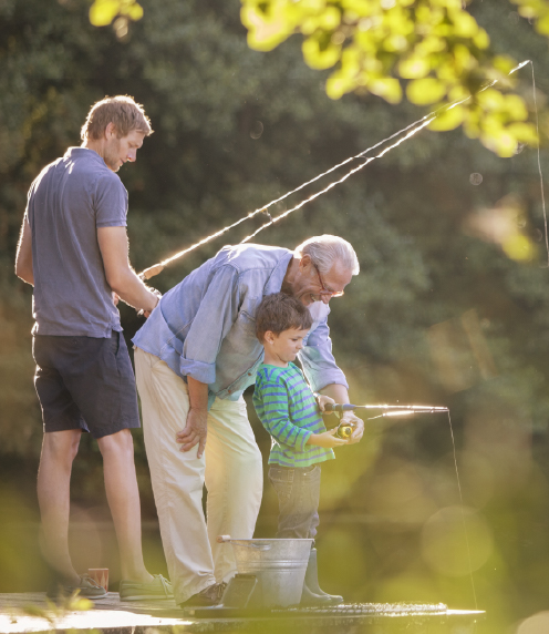 Grandfather, father, and young son fishing