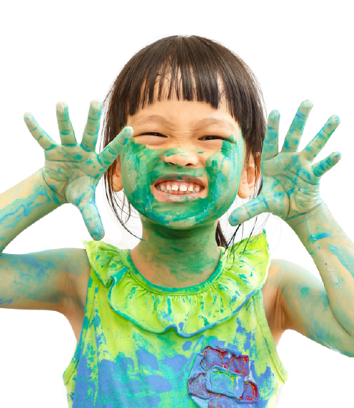 Little girl covered in green paint