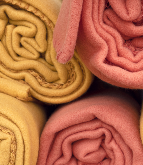 Orange and rose rolls of fleece fabric
