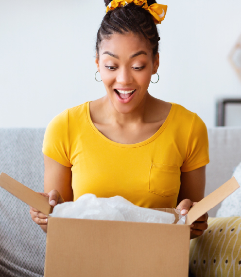 Woman opening a box, surprised