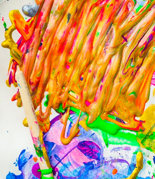 Paint brush with messy, colorful paint