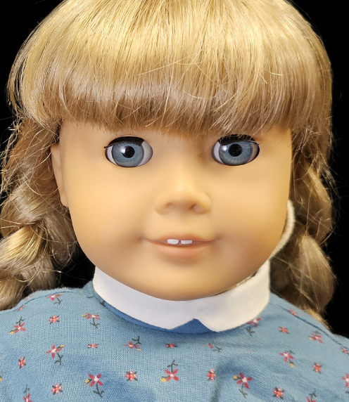Blonde American Girl doll with blue eyes and a blue dress