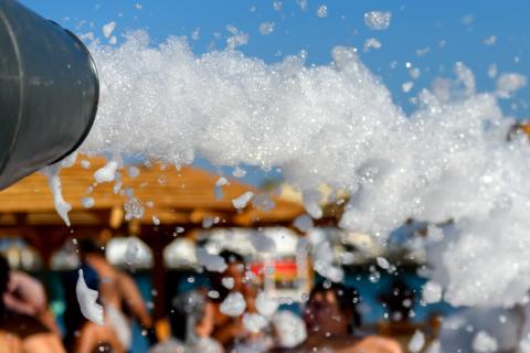 Foam cannon spraying foam at party-goers