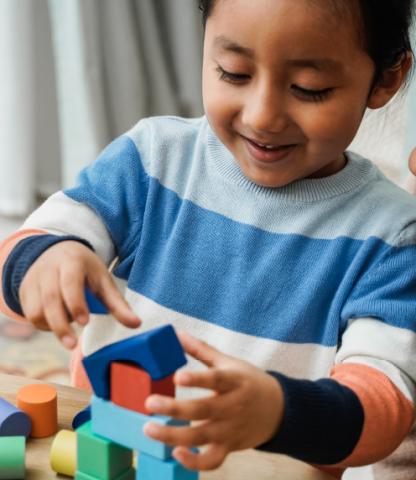 Toddler building with blocks