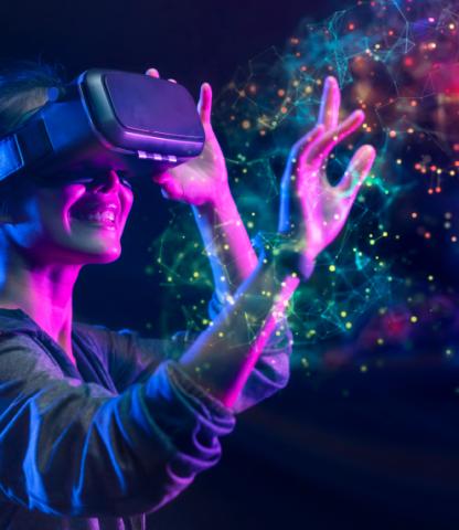 Young woman wearing VR headset, reaching out to touch multi-colored lights