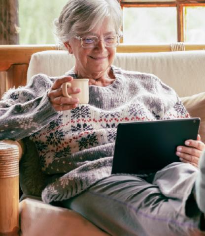 Mature woman sitting with coffee and a table