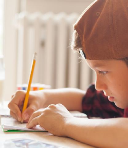 Young boy writing