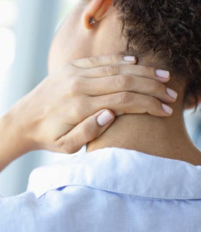 Woman rubbing the back of her neck