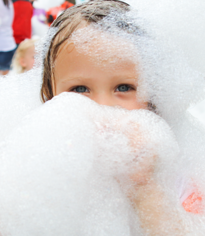 Young girl covered in foam