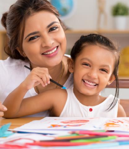 Mother and daughter with a paint brush