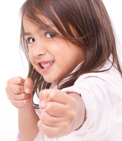 Little girl punching at camera