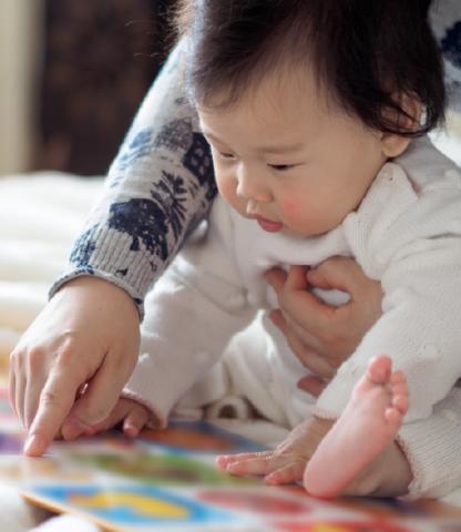 Infant looking at book