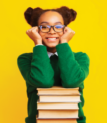 Young woman resting her elbows on a stack of books