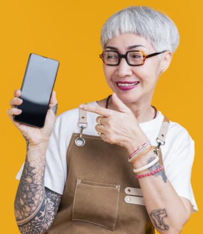Happy senior woman pointing at her smartphone