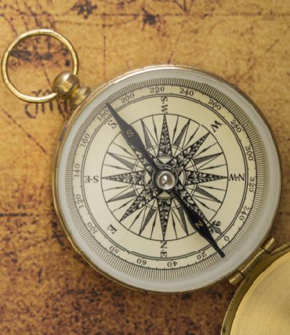 Compass on old parchment map