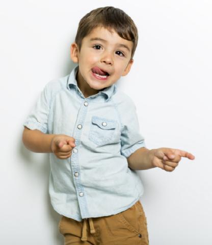 Little boy dancing while making a funny face