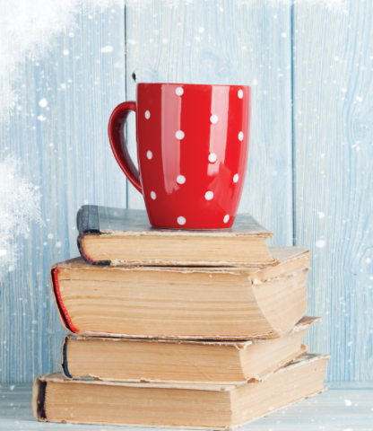 Cup sitting on books with wintery background