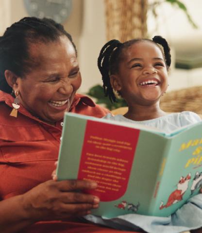 Grandmother and toddler reading together