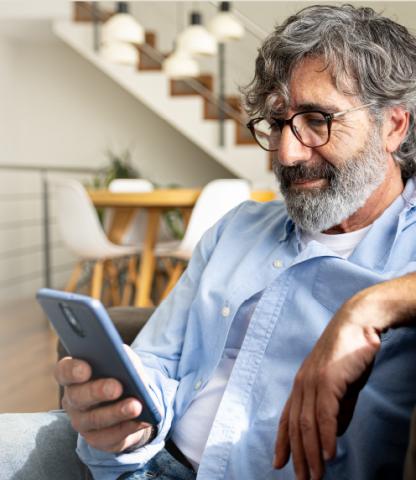 Mature man looking at his smartphone