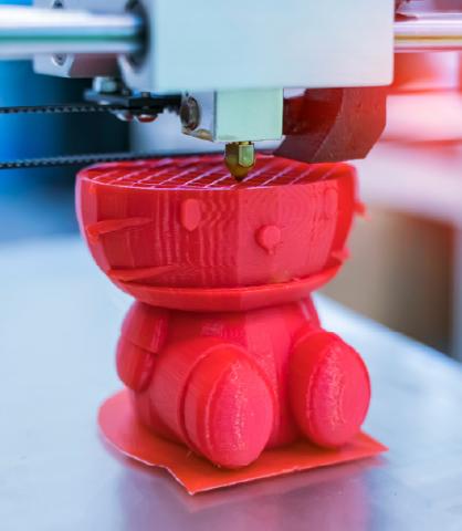 3D printer making red Hello Kitty figurine