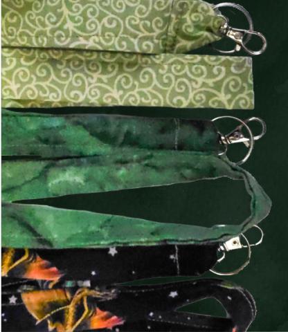 Three handmade lanyards in various fabrics