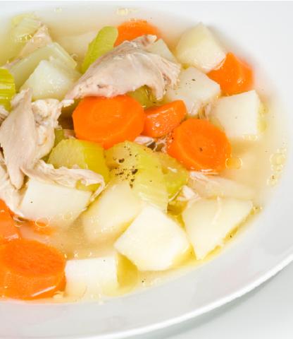 Close up of a bowl of chunky chicken noodle soup