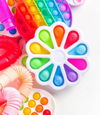 A pile of colorful fidget toys and poppers