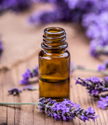 Small, brown glass bottle surrounded by lilac