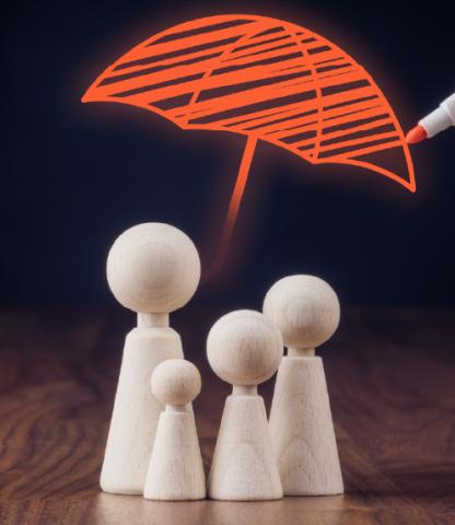 Family made of four wooden figures with a hand-drawn umbrella over them