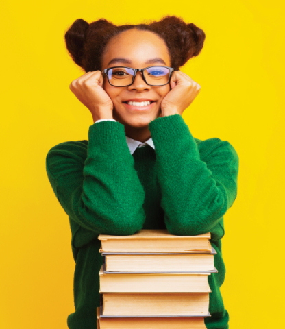 African American woman sitting with a stack of books on a yellow background
