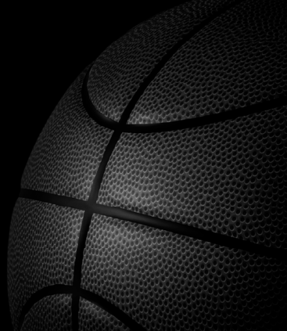 Black basketball fading into a black background