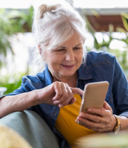 Senior woman scrolling through her phone