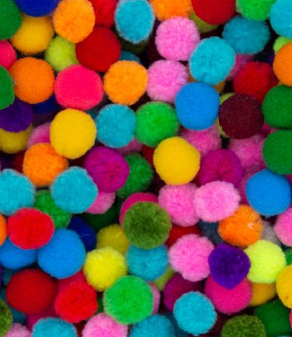 Pile of multi-colored pom-poms