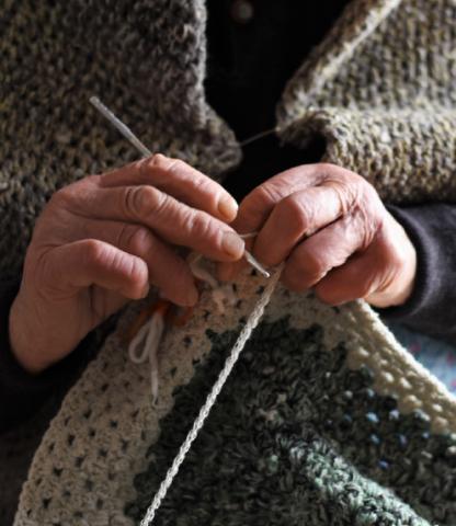 Close up of mature woman's hands as she crochets