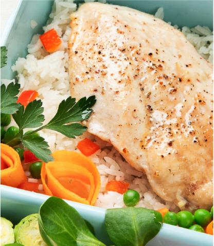 Prepped meal of salmon and veggies in a plastic container