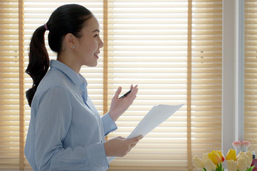 Woman practicing speech in a mirror