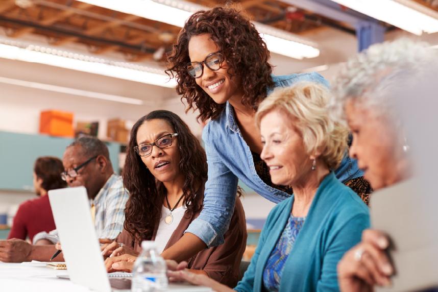 Group of people watching instructor motion to computer screen