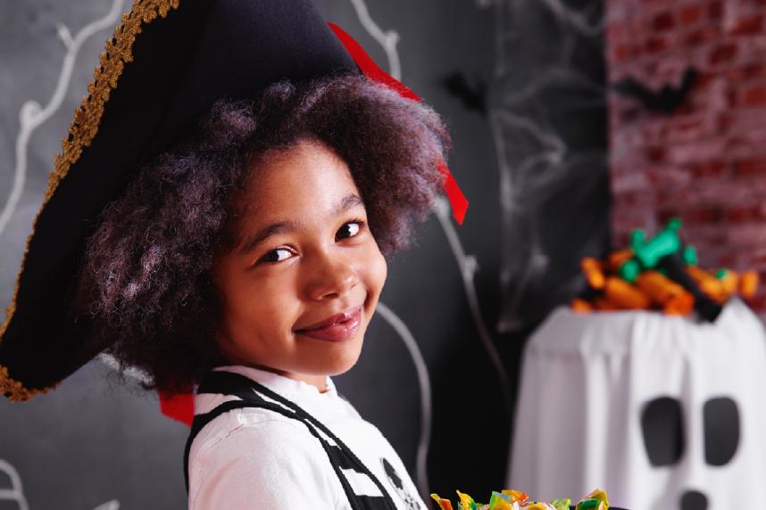 Young, smiling girl dressed as pirate