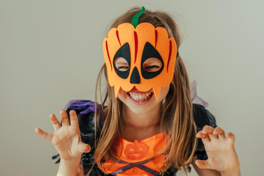 Girl wearing Jack-o-Lantern mask