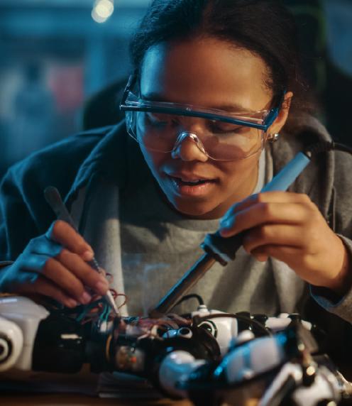 Teenage girl using a soldering iron