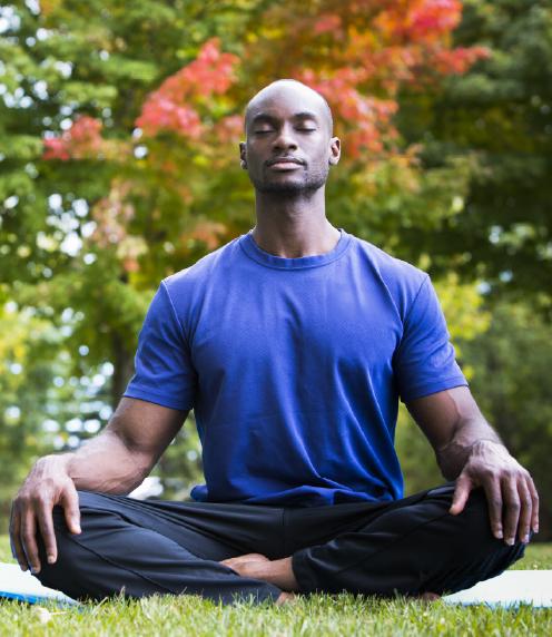 Man sitting outside in lotus position