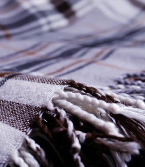 Close up of a tartan-patterned fleece blanket