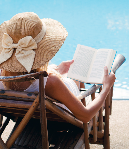 Woman reading book on beach