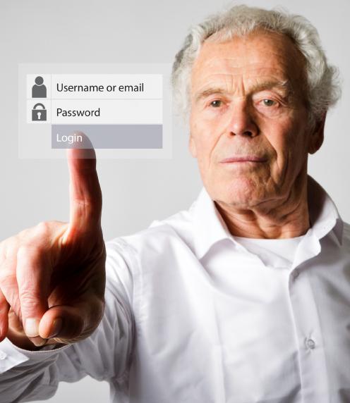 Senior man using touchscreen to login to an account