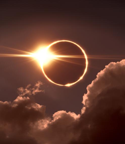 Photo of a total solar eclipse with clouds